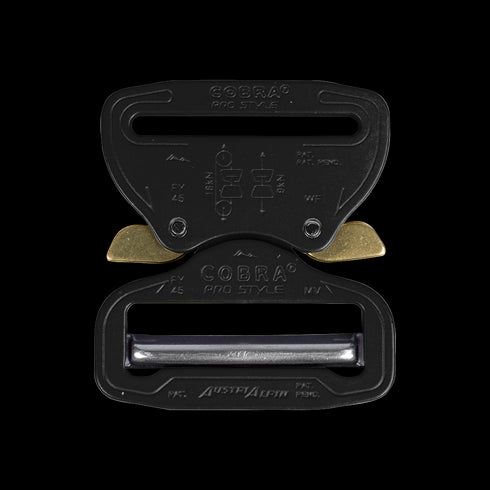 The Austrialpin Cobra Buckle - Pro Style features a black and gold metal quick-release design with engraved instructions—ideal for bushcraft adventures or law enforcement gear.